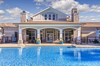 A large house with a pool in front at Crabtree Lakeside Apartments, Raleigh
